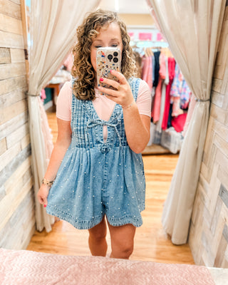 a pearl denim jumper paired with a basic bodysuit