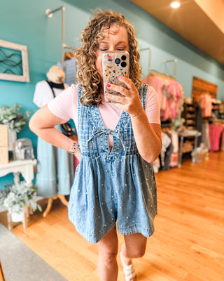 a pearl denim jumper paired with a basic bodysuit