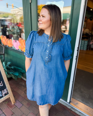 a short sleeve denim chambray dress with pearl button ruffle details