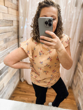 A floral flutter sleeve rib knit top in peach
