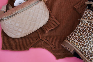 Rust colored sweater with an uneven style hem