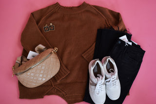 Rust colored sweater with an uneven style hem