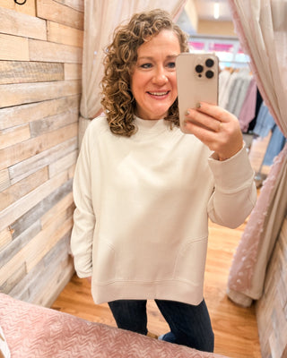 a long sleeve pullover in scuba soft material with a side slit