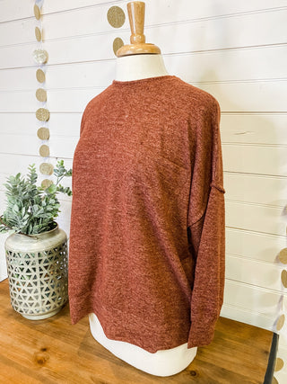 Brushed melange style oversized sweater in a rust color