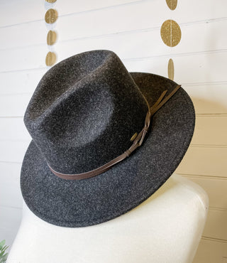 a felt wide brim hat with leather belt strap