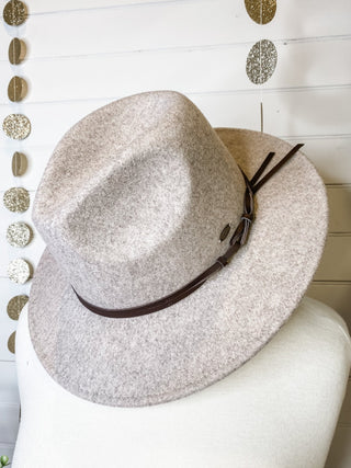 a felt wide brim hat with leather belt strap