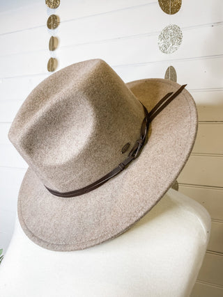 a felt wide brim hat with leather belt strap