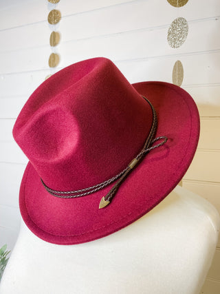 a felt wide brim hat with leather belt strap