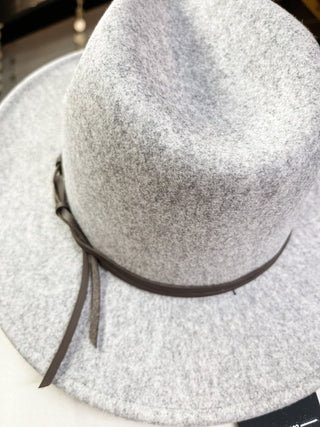 a felt wide brim hat with leather belt strap