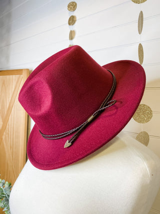 a felt wide brim hat with leather belt strap