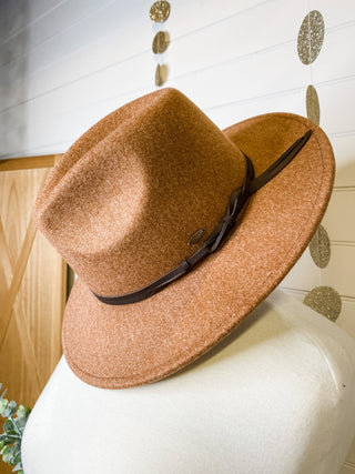 a felt wide brim hat with leather belt strap