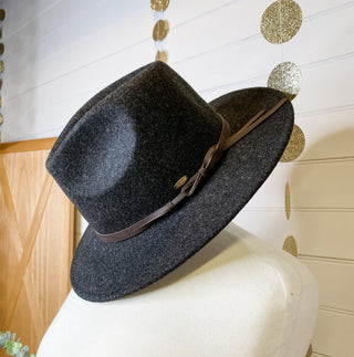 a felt wide brim hat with leather belt strap