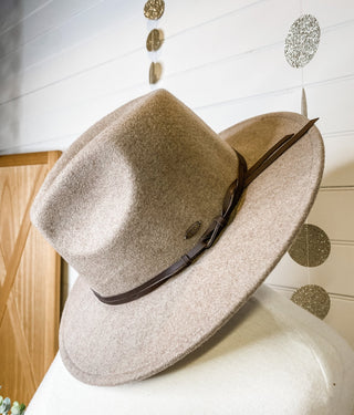 a felt wide brim hat with leather belt strap