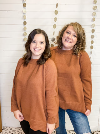 Rust colored sweater with an uneven style hem