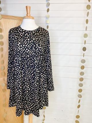 A gold foil polka dot mini dress with long sleeves