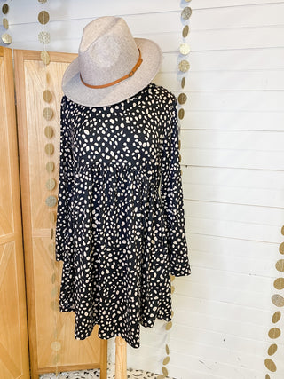 A gold foil polka dot mini dress with long sleeves
